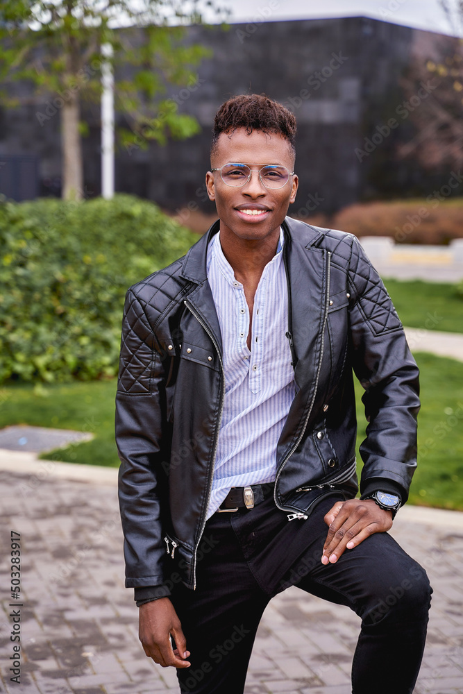 African American male model posing in a park looking at the camera. High quality photo African American male model posing in a park looking at the camera. High quality photo