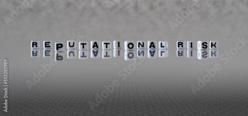 reputational risk word or concept represented by black and white letter cubes on a grey horizon background stretching to infinity