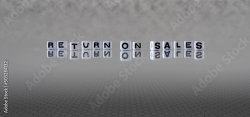 return on sales word or concept represented by black and white letter cubes on a grey horizon background stretching to infinity