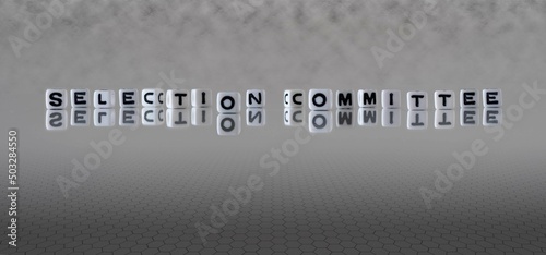 selection committee word or concept represented by black and white letter cubes on a grey horizon background stretching to infinity