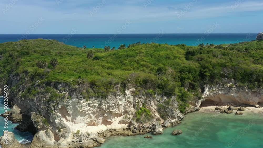 Stone cliff washes with Atlantic ocean. Macao beach. Dominican Republic. Aerial pristine and bounty view Stone cliff washes with Atlantic ocean. Macao beach. Dominican Republic. Aerial pristine and bounty view