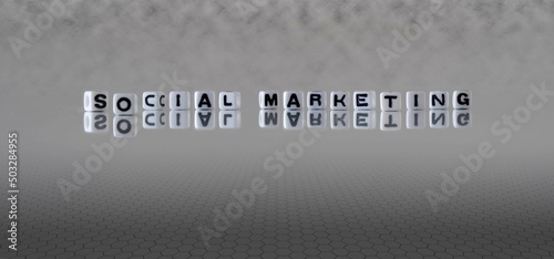 social marketing word or concept represented by black and white letter cubes on a grey horizon background stretching to infinity