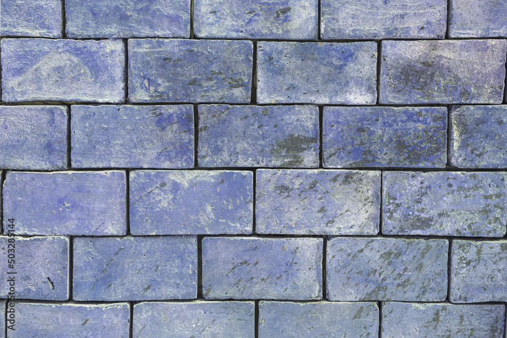 The background texture of a brick wall is light blue , purple shades are large blocks The background texture of a brick wall is light blue , purple shades are large blocks
