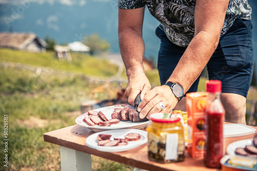 Man cutting traditional Kosovo sausage Suxhuk, Decan, Kosovo
