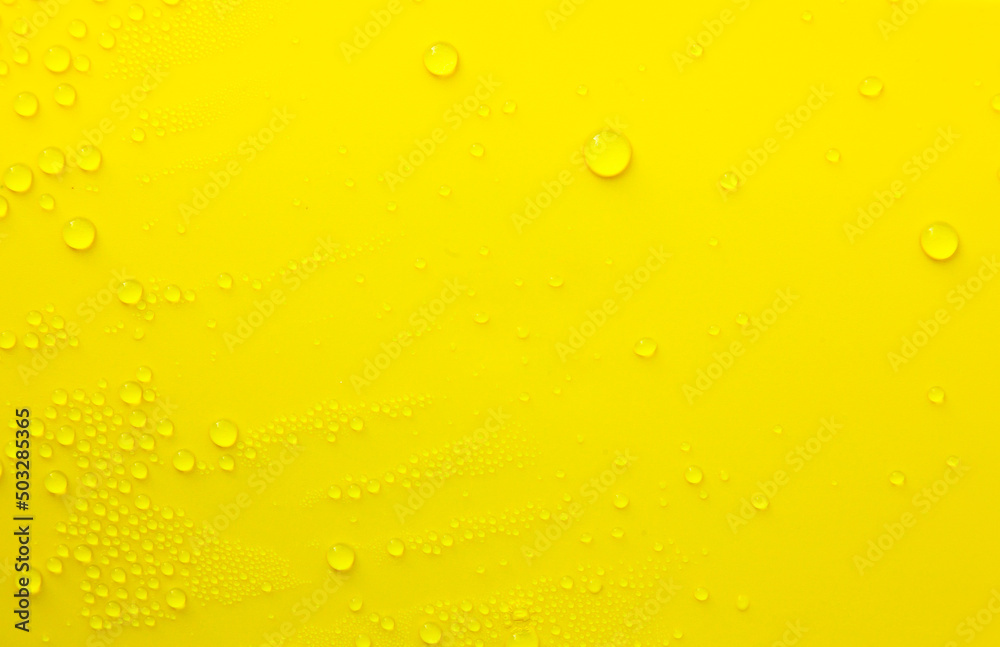 Water drops on a yellow background. Water drops on a yellow background.