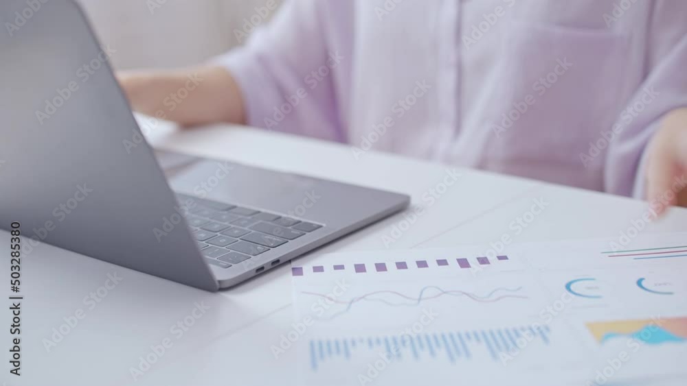 Woman sale manager analyzing data, typing on laptop, preparing annual report