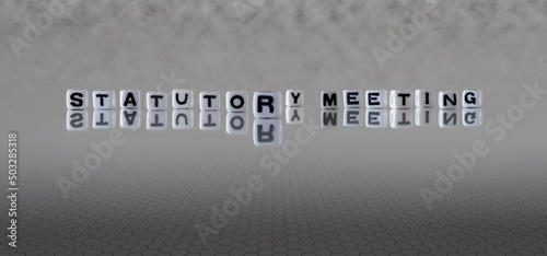 statutory meeting word or concept represented by black and white letter cubes on a grey horizon background stretching to infinity