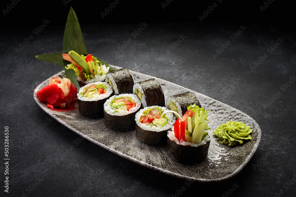 Sushi roll Yasai on a dark plate Sushi roll Yasai on a dark plate