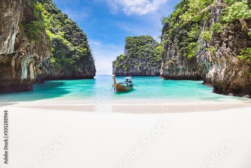 Tela Thai traditional wooden longtail boat and beautiful beach in Phuket province, Thailand