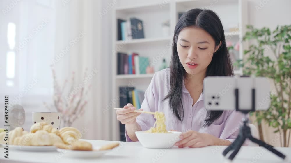 Young woman eating noodles on camera for show, collecting subscribers, mukbang Young woman eating noodles on camera for show, collecting subscribers, mukbang