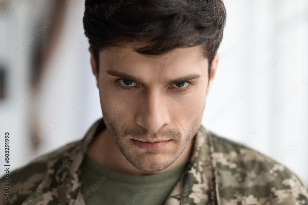 Angry military man looking at camera, closeup shot Angry military man looking at camera, closeup shot