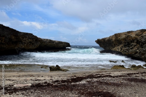 seascape at Boka Kalki in the Shete Boka National park,
waves entering the mouth of the bay photo
