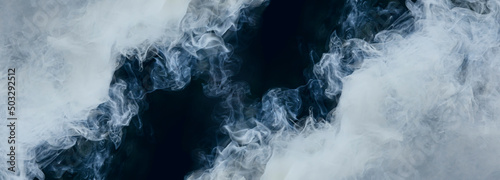 The abstract fog or smoke moves on black background, with White cloudiness, mist, or smog background for your logo wallpaper or web banner.