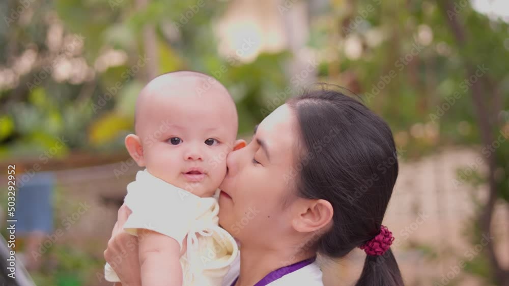Cute, newborn Asian baby boy. Family happy, Asian young mother is playing, carry and taking care with love, happy smile face. Little innocent new infant child in first day of life. Mother day concept. Cute, newborn Asian baby boy. Family happy, Asian young mother is playing, carry and taking care with love, happy smile face. Little innocent new infant child in first day of life. Mother day concept.