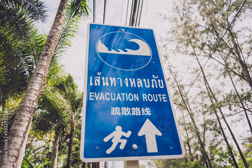 A sign showing a tsunami evacuation route at island in Thailand