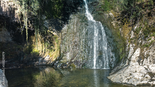 Beautiful and original panorama. Beautiful and majestic landscape and panorama of a mountain waterfall, a river, in textured and hard rocks and stones in the afternoon in the summer. High quality