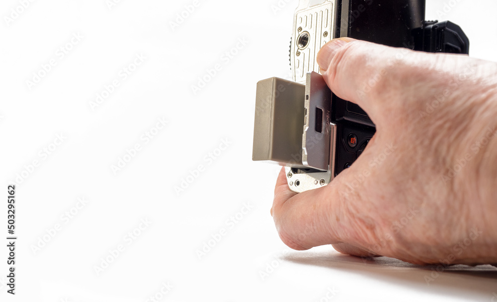 Studio Photographer changing Lithium ion battery in his DSLR camera white background Selected Focus Studio Photographer changing Lithium ion battery in his DSLR camera white background Selected Focus