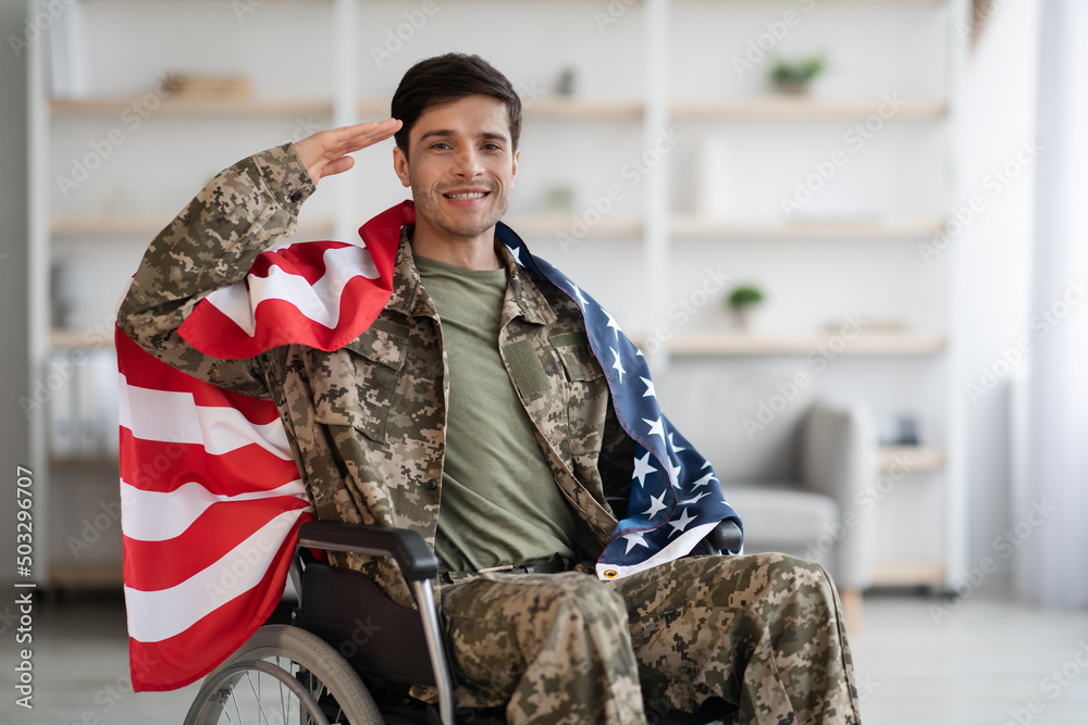 Fototapeta premium Patriotic veteran sitting in wheelchair with flag of the US