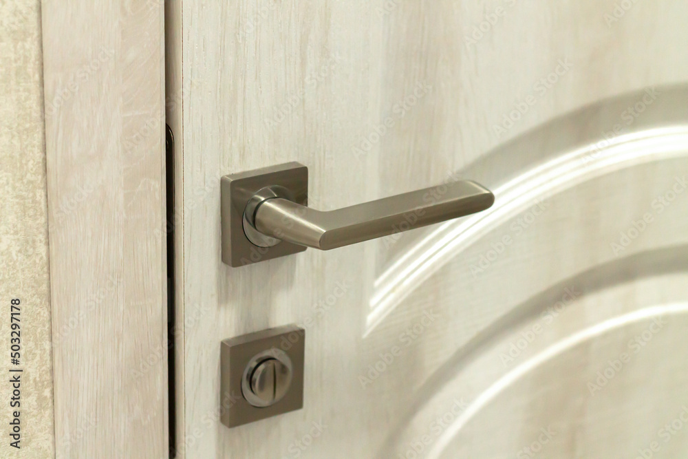 Door handle or doorknob with security lock on wooden background Door handle or doorknob with security lock on wooden background