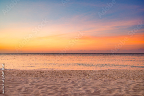 Fototapeta Naklejka Na Ścianę i Meble -  Closeup sea sand beach. Panoramic beach landscape. Inspire tropical beach seascape horizon. Orange and golden sunset sky calmness tranquil relaxing sunlight summer mood. Vacation travel holiday banner
