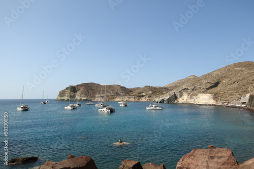 Boats floating in the bay of Red Beach, Santorini, Greece