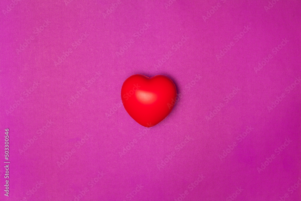 Top view or flat lay of red heart pillow on purple background with copy space, isolated. Valentine's day concept.