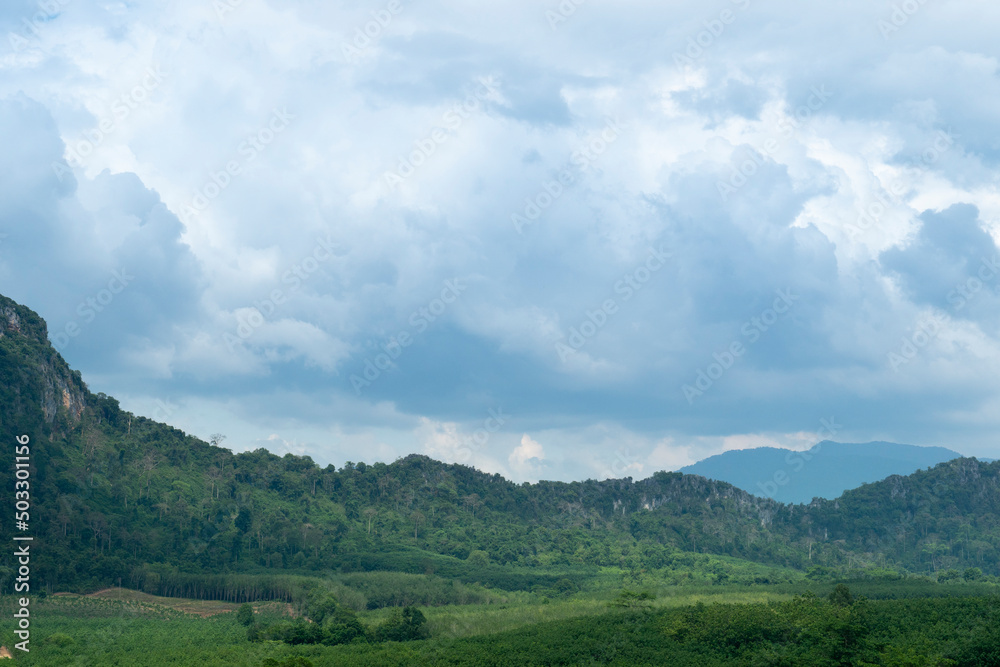 Landscape view of hills covered with trees. Under blue sky and white clounds. At Wang Chan, Rayong Thailand.