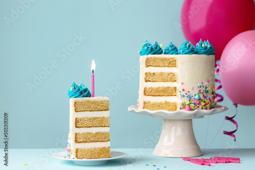 Birthday cake with slice removed and pink candle