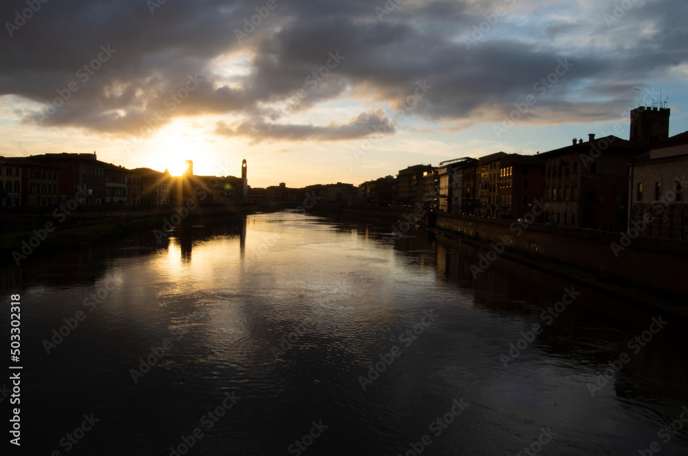 A sunset view of the Arno, Pisa's and Florence's river, after a rainy day. 
