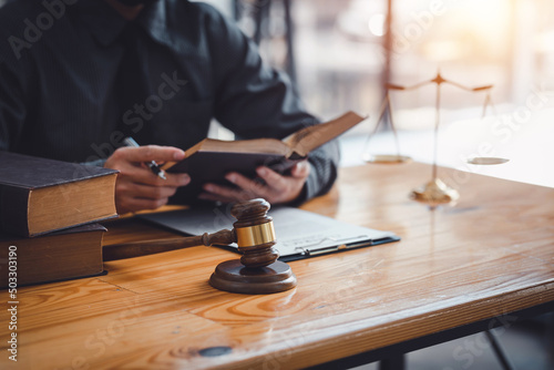 Lawyer working on a document in the office. Legal law, advice and justice concept.