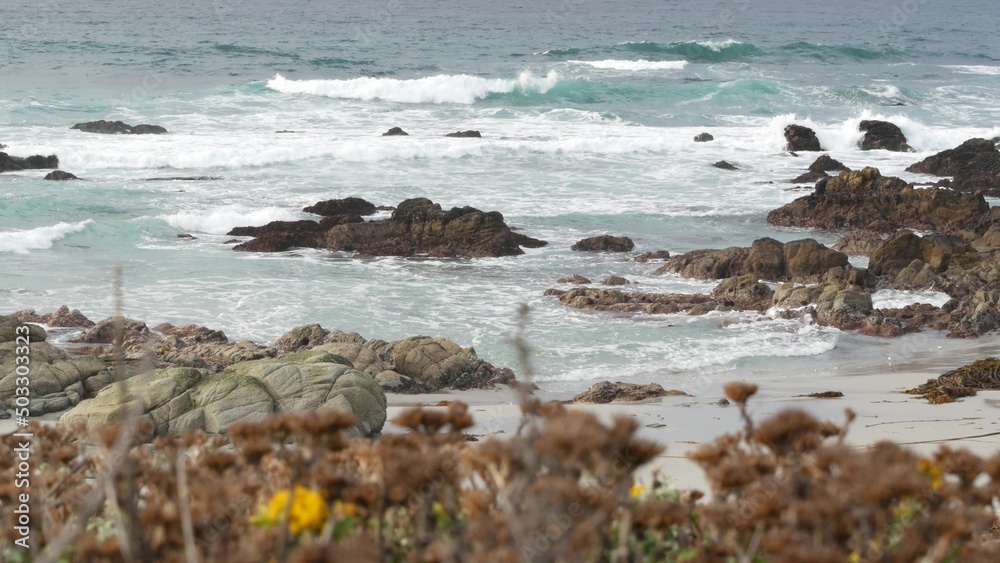 Rocky craggy pacific ocean coast, sea water waves crashing on rocks, 17-mile drive, Monterey, California USA. Gloomy nature near Point Lobos, Big Sur, Pebble beach. Dramatic cloudy rainy cold weather.