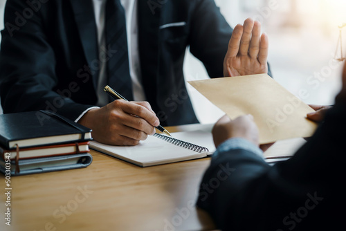 Lawyer refuses to accept bribe from business people in contracting. Corruption and anti bribery concept.