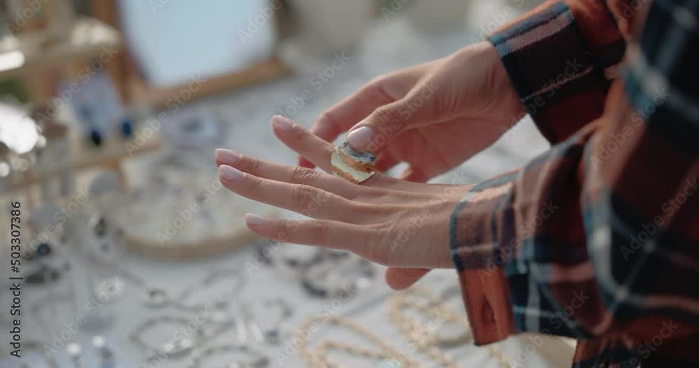 Girl`s hands choosing the handmade jewellery  on the local fair outside. Shallow depth of field, shallow focus. Hand held