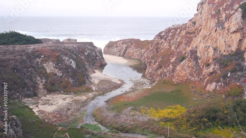 Obraz na plátně River or creek estuary in canyon, sea ocean beach and stream flow, mountain cliff or steep bluff crag