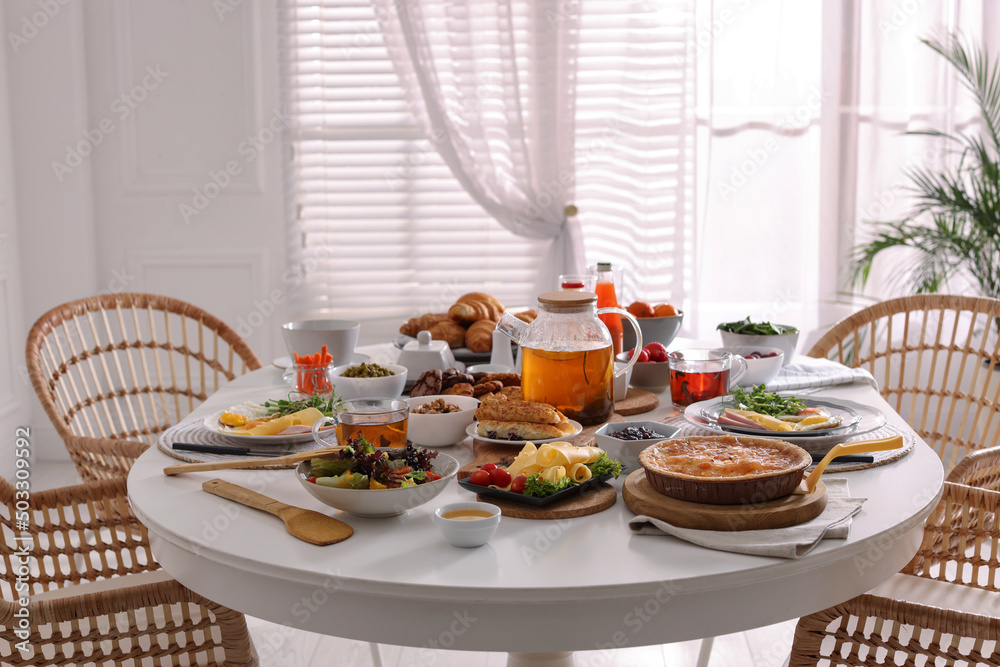 Many different dishes served on buffet table for brunch