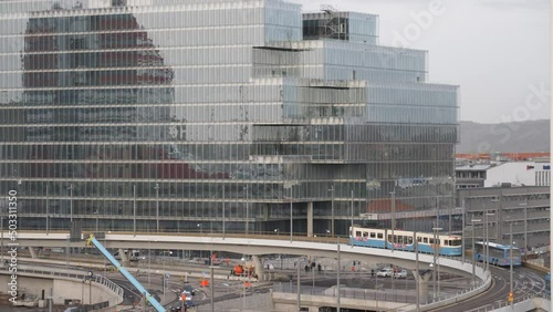 Glass facade with reflection of The Lipstick (Lilla Bommen) and Tram Passing in Central Gothenburg, Slow-motion photo