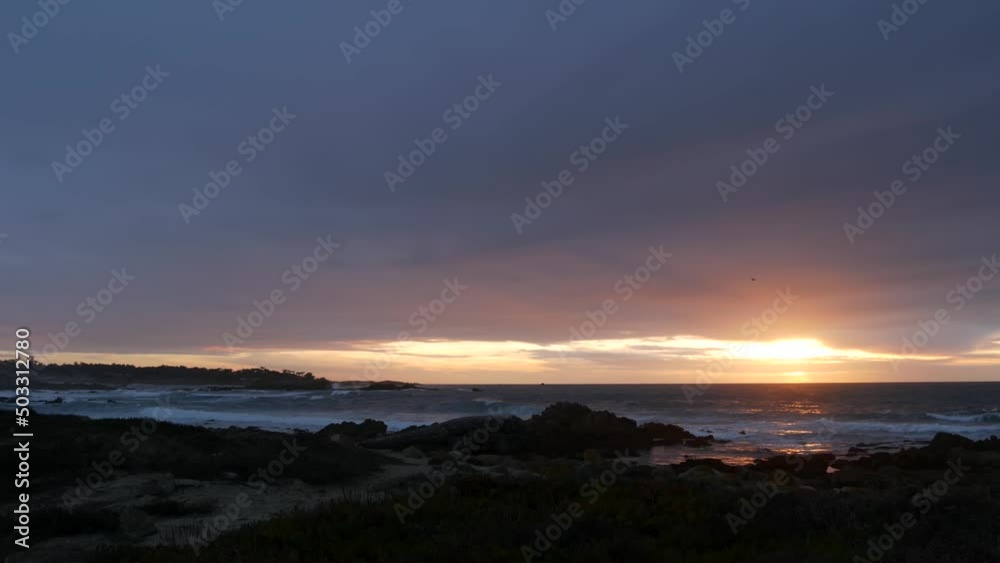 Rocky craggy pacific ocean coast, sea water waves crashing on rocks, 17-mile drive, Monterey California USA. Dramatic sunset sky nature near Point Lobos, Big Sur, Pebble beach. Rainy cloudy weather. Rocky craggy pacific ocean coast, sea water waves crashing on rocks, 17-mile drive, Monterey California USA. Dramatic sunset sky nature near Point Lobos, Big Sur, Pebble beach. Rainy cloudy weather.