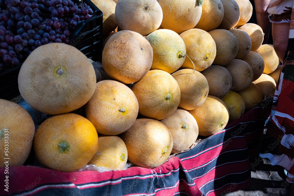 Cantaloupe melon, muskmelon, fruit piled up in a city market in Egypt. Fresh, healthy and juicy melons, ready to eat.