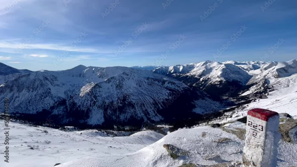 Panoramic view of snow-covered mountain peaks on a sunny day Panoramic view of snow-covered mountain peaks on a sunny day