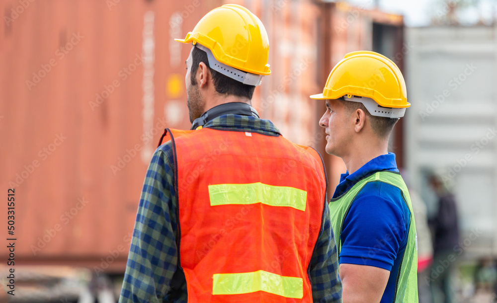 Supervisor and foreman worker team in the container yard, Industrial engineer and inspector or safety supervisor working in container terminal, Logistics concepts Supervisor and foreman worker team in the container yard, Industrial engineer and inspector or safety supervisor working in container terminal, Logistics concepts