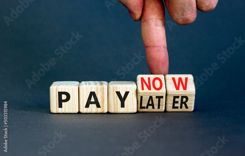 Pay later or now symbol. Businessman turns wooden cubes and changes concept words Pay later to Pay now. Beautiful grey table grey background. Business pay later or now concept. Copy space.