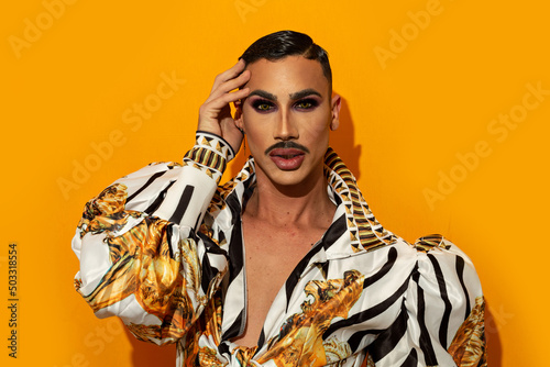 Obraz na płótnie Portrait of drag queen with fashionable mustache yellow background