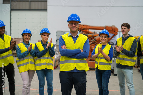 Group of workers applauding the promotion of their colleague