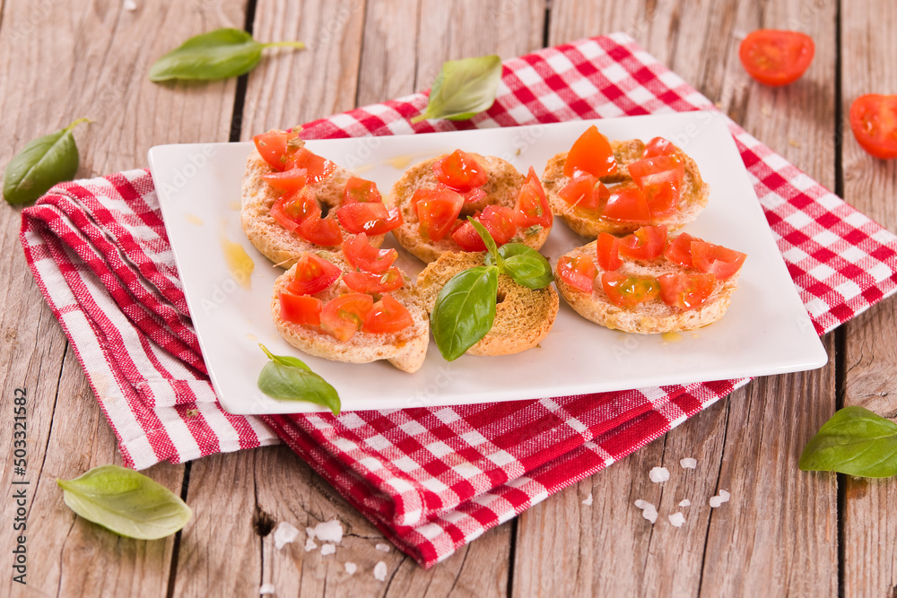 Friselle with cherry tomatoes and basil. Friselle with cherry tomatoes and basil.