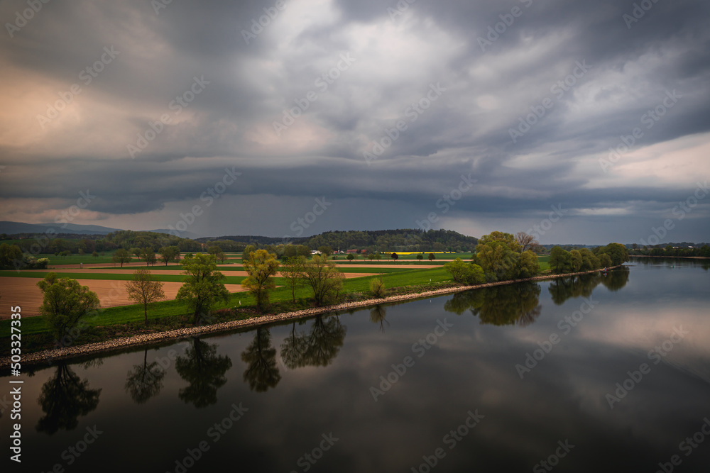 Obraz premium Dark storm clouds in the evening sky at the Danube in Bavaria, Germany