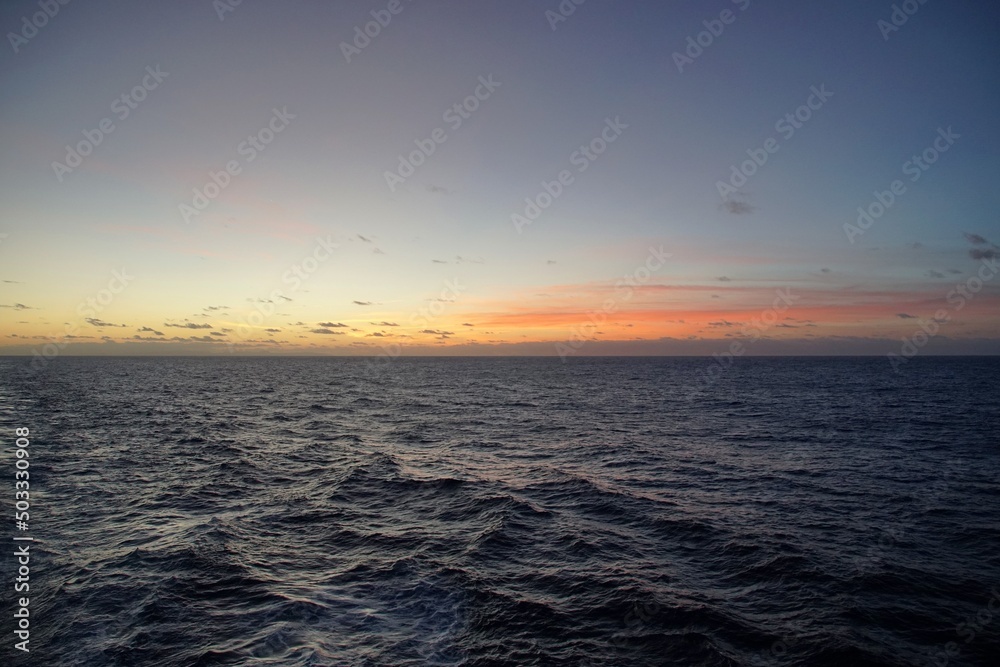 Fototapeta premium The magic of the ocean. Sunrise over the Atlantic. Horizon and endless space. Beautiful view. Clouds 