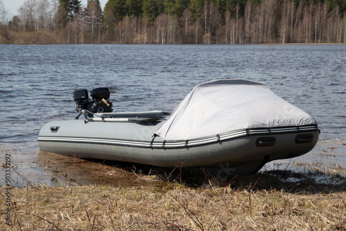 A rubber boat with an outboard motor on the lake.