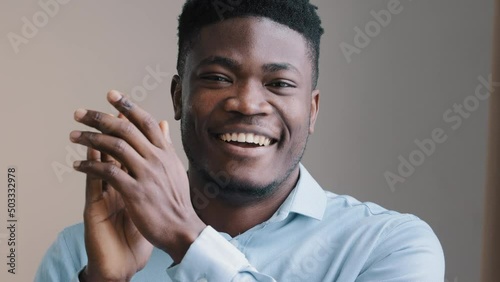 Amazed young african man happy american winner employee waving clapping hands approve looking at camera show thumb up agreement sign everything fine satisfied work result good choice close-up portrait photo