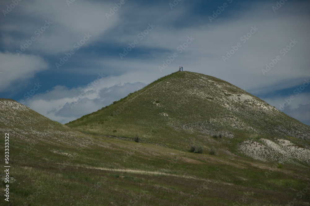 picturesque hills against the sky. summer green hills against a clear sky picturesque hills against the sky. summer green hills against a clear sky