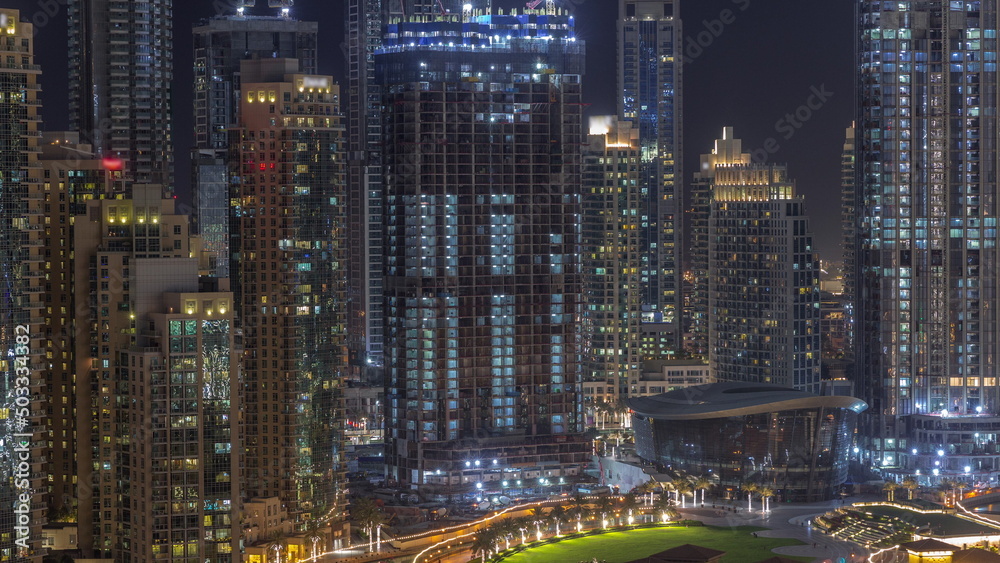Futuristic aerial night cityscape timelapse with illuminated architecture of Dubai downtown, United Arab Emirates.